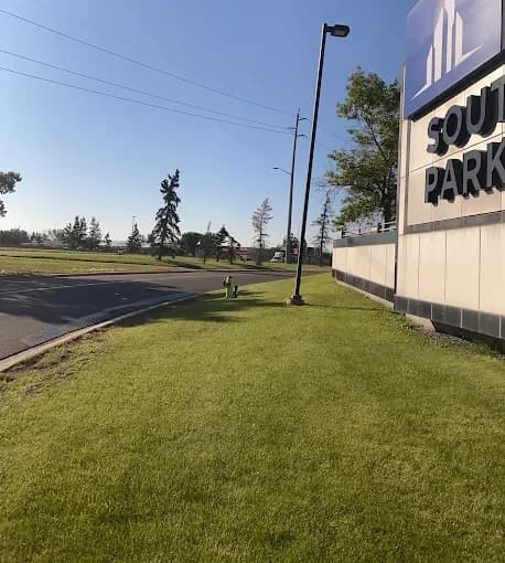 Mowed and trimmed turf along a business park's road edge.